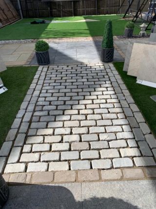 Kandla Grey tumbled cobbles 200x100 in display area at Melton Stone