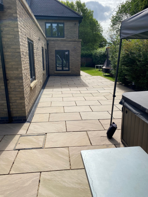 House extension using Raj Green 600x900 riven Indian sandstone patio slabs