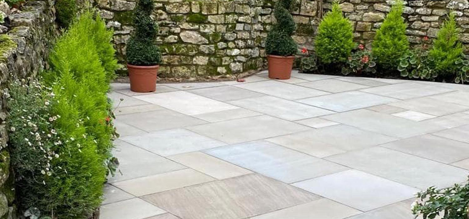 Indian Sandstone Paving in a garden with brick wall